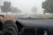 Car driving in thick fog