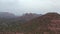 Car driving towards Cathedral Rock, Sedona Arizona, aerial rising reveal