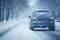 A car driving in winter in dangerous snow and icy conditions