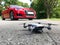 Car and drone parked on the road