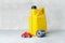 Car engine oil change concept with yellow oil canister, oil filter and little car