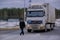 A car with export goods on the territory of the customs post. The representative of the state organ - the customs officer in unifo