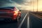 Car on the expressway, close-up. A modern car speeds along the evening highway at sunset. A fast sports car drives in the