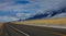 Car far in the distance drives along the scenic freeway running across Montana