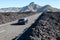 Car fast driving on the route TF-38 in the middle of volcanic lava pebbles on asphalt road. Canary, Tenerife