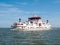 Car ferry boat with passengers sailing on Waddensea from Frisian island Ameland to Holwerd in Friesland, Netherlands