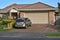 car in front of suburban garage