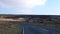 Car front view driving in dreary moorland landscape