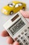 Car and hand holding a pocket calculator with Leasing text