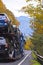 Car hauler semi truck transporting cars on spectacular autumn hi