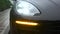 Car headlight flashing in the rain