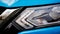 Car headlight and hood. Blue compact SUV car with sport and modern design.