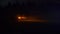Car headlights glow orange in the dark outside. Blinking alarm light. Cinematic concept