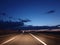 car headlights illuminate the night highway, dangerous night-time driving