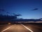 car headlights illuminate the night highway, dangerous night-time driving