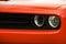 Car headlights. Luxury Headlights. Front of the car close up. Red car