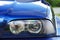 Car headlights. Luxury Headlights. Part of a blue car