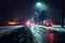 car headlights shining on icy road at night