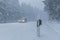 Car with illuminated lights passing through heavy snowy weather at the Grosser Feldberg in Germany