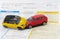 Car insurance report following an accident concept with toy cars on accident statement