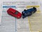 Car insurance report following an accident concept with toy cars on accident statement