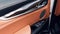Car interior. Car door interior trim. Soft focus. Black and brown leather car interior. Modern car illuminated dashboard