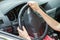 Car interior. Dashboard and woman hands on steering wheel driving a car