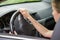 Car interior. Dashboard and woman hands on steering wheel driving a car