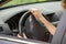 Car interior. Dashboard and woman hands on steering wheel driving a car