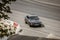 car Jaguar XJ6 1973 model on the street. Aerial view of black auto turning from motorway