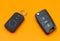 Car key with remote alarm control on the orange background