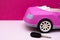 Car keys and pink car mockup. Concept of car sale, car rental.