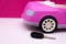 Car keys and pink car mockup. Concept of car sale, car rental.