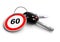 Car keys with speed limit road sign on keyring.