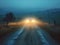 car light traveling on foggy night road