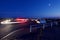 Car lights illuminate parking lot at view point on a clear summer evening, Mount Tolmie, Victoria BC