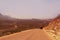 The car loaded with things goes on a deserted road in a wild landscape. Yemen. Sokotra. spirit of adventurism and adventure.