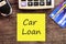 Car loan concept with text,calculator and credit card and car key ,calculating for debt payment background