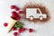 Car made of cocoa powder and raspberries on a light background. Online shopping. The concept of delivery services, logistics,