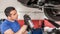 Car master mechanic repairer lubricates screws with machine cleaner spray