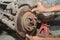 Car Mechanic Assemble Disk Brake to Car Wheel Hub