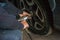 A car mechanic changes a tire on a wheel