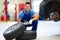 Car mechanic crouching down by a pair of wheels