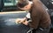 Car mechanic with dust mask grinds a car part in a service station - Serie car repair workshop