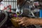 Car mechanic fills a fresh lubricant engine oil