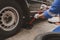 Car mechanic is inspecting tires and replacing worn tires through long hours of work, car repairs, car breakdowns, punctured tires