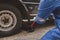 Car mechanic is inspecting tires and replacing worn tires through long hours of work, car repairs, car breakdowns, punctured tires