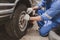 Car mechanic is inspecting tires and replacing worn tires through long hours of work, car repairs, car breakdowns, punctured tires