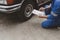 Car mechanic is inspecting tires and replacing worn tires through long hours of work, car repairs, car breakdowns, punctured tires