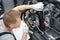 Car mechanic inspects motorcycle breakdowns in car repair shop